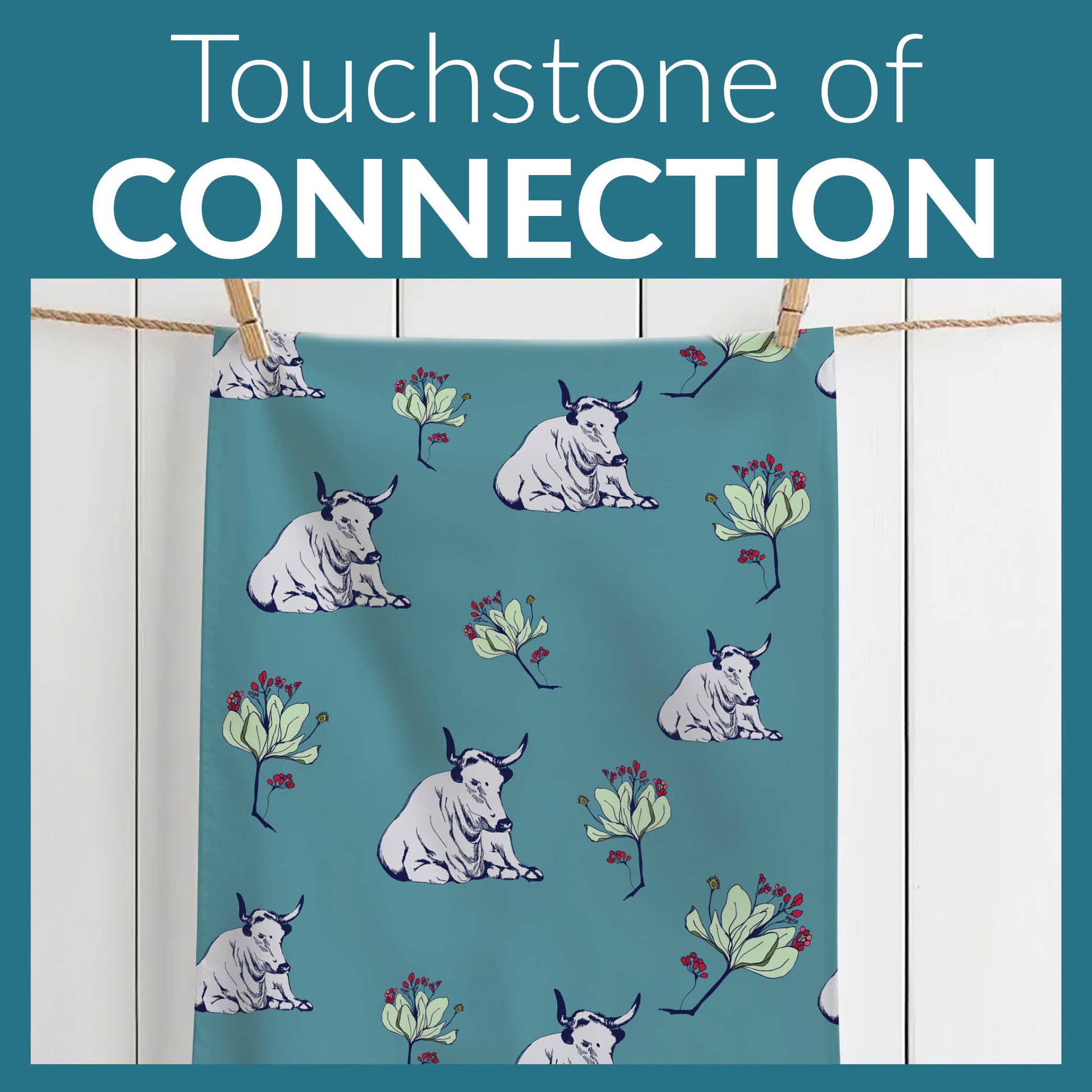 Wild Nguni Tea Towel online showing cows and and flower pattern on a teal background, with text 'Touchstone of Connection' at the top.