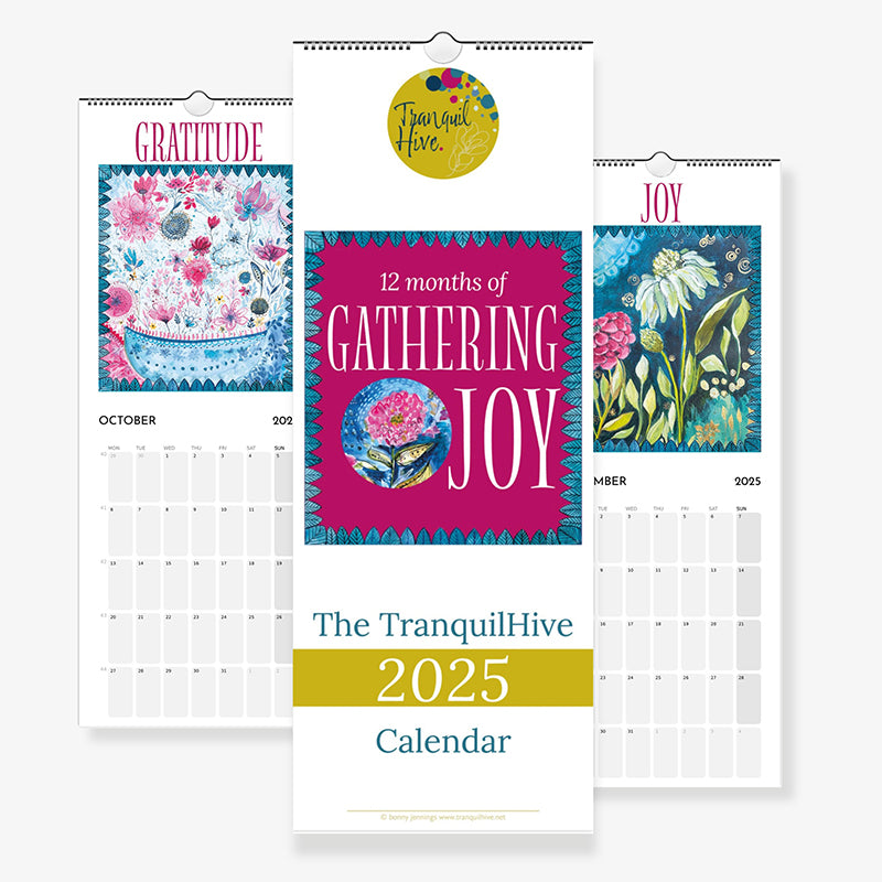 Picture of the front cover and two pages of the calendar. Gathering Joy is the title. The colours are bold and joyful.